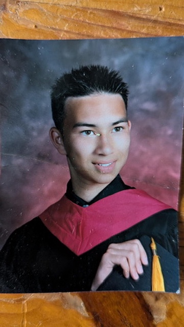 Will as a young man in a graduation gown and honor cords.